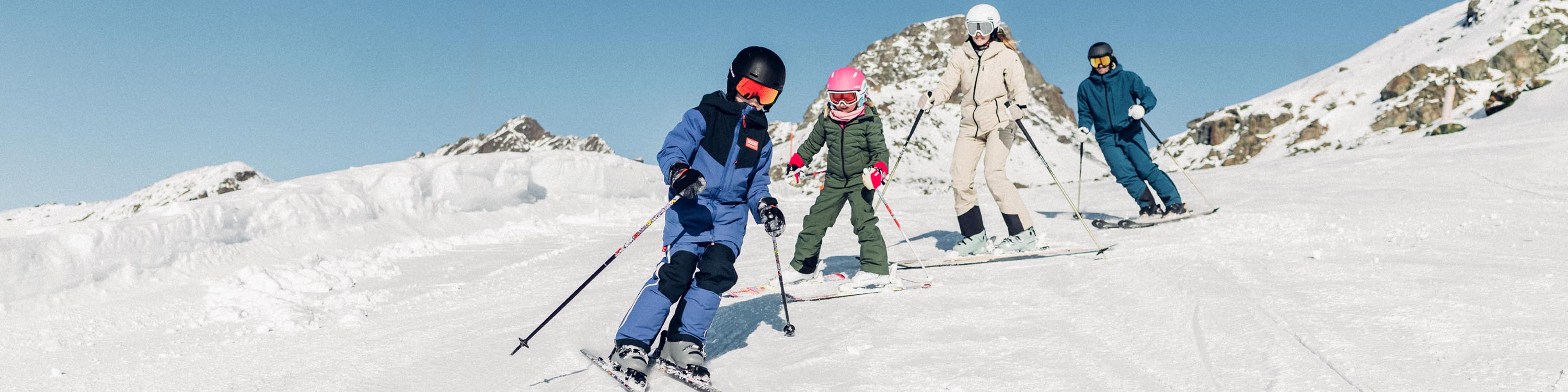 Image of family skiing down a mountain.
